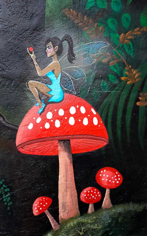 blue fairy on mushroom mural